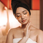 Skincare 9 Pacified girl after shower in towel poses with eye patches